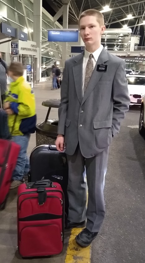 Matthew standing with his luggage